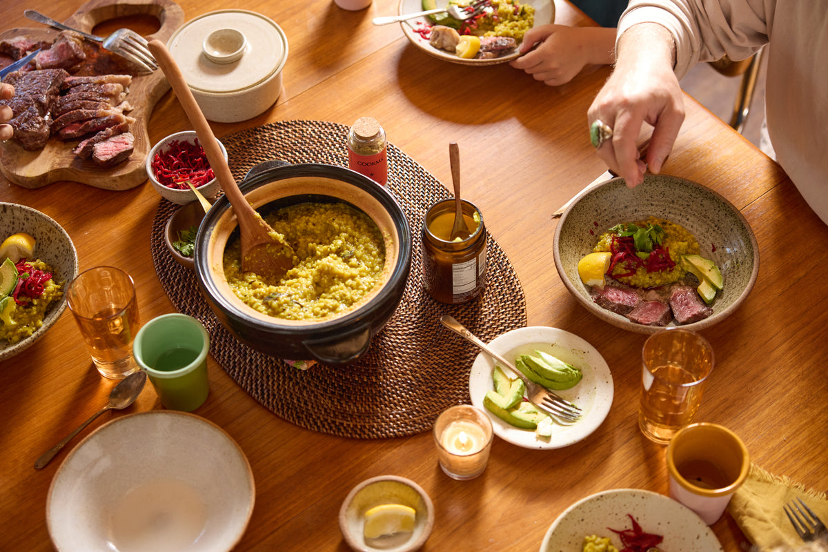 Hands reaching across a shared family table
